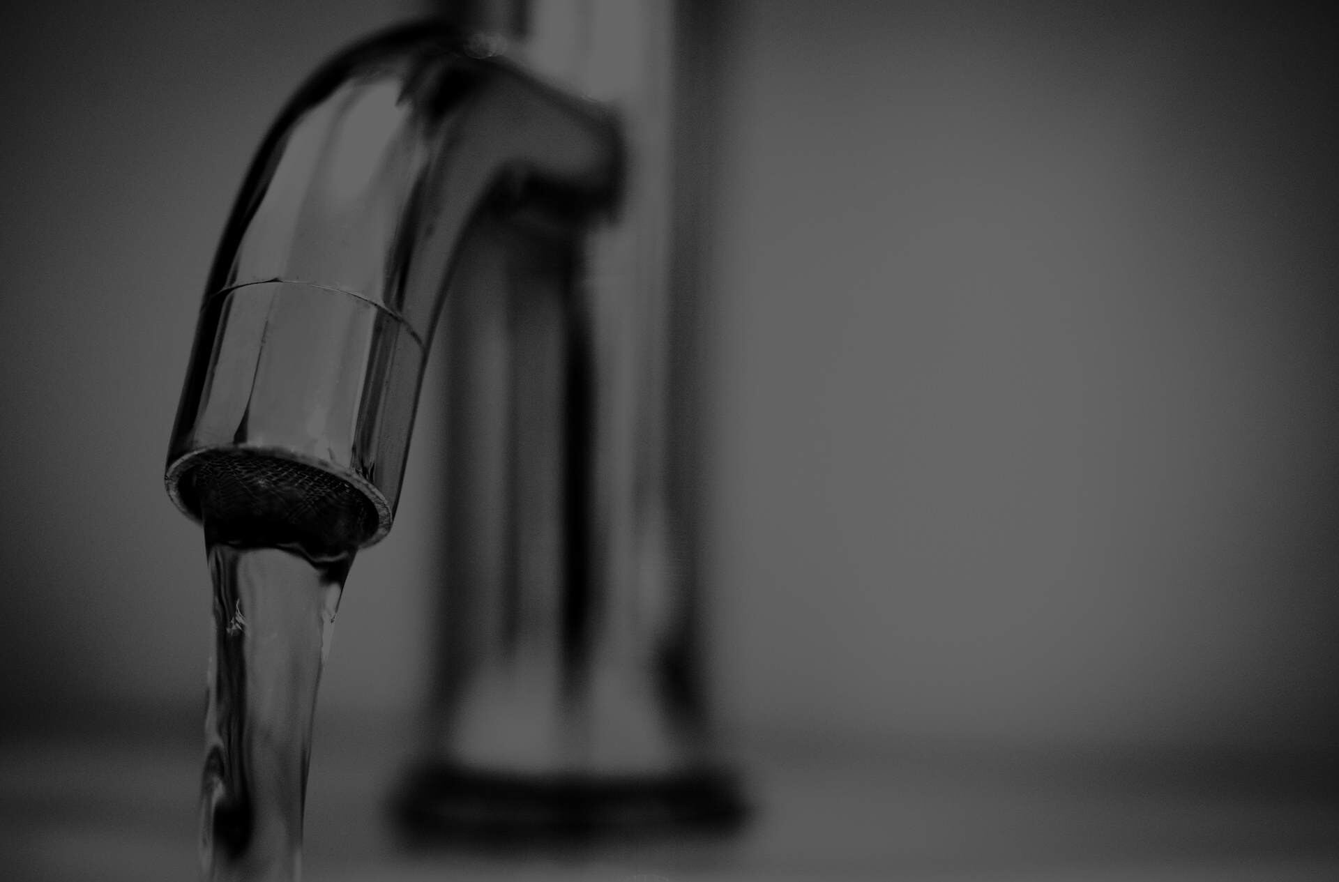 Close-up of a chrome tap with running water